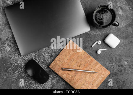 Laptop, headphones, pens and plant on old wooden table Stock Photo