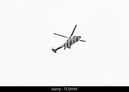 Military navy helicopter flying isolated on white background Stock Photo
