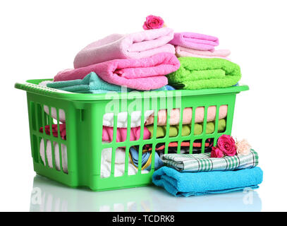 Towels in green plastic basket isolated on white Stock Photo