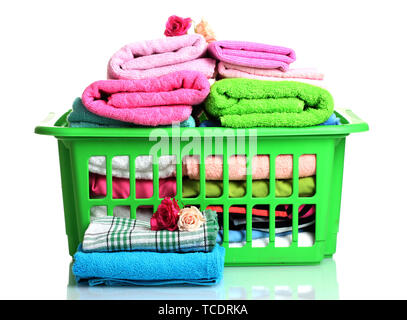 Towels in green plastic basket isolated on white Stock Photo
