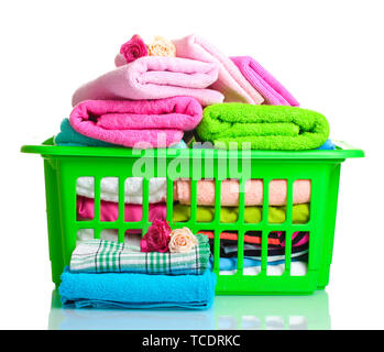 Towels in green plastic basket isolated on white Stock Photo