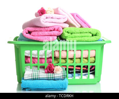 Towels in green plastic basket isolated on white Stock Photo
