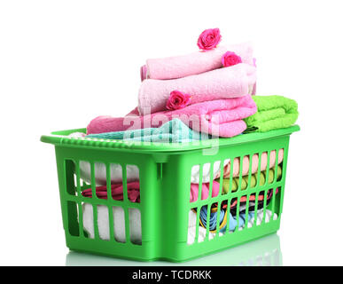 Towels in green plastic basket isolated on white Stock Photo