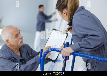 woman apprentice in front of painter Stock Photo