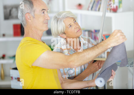 happy senior couple doing diy Stock Photo