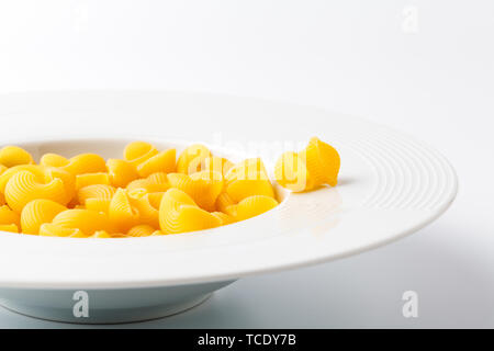 Raw elbow Macaroni (Gomiti Pasta) in bowl Stock Photo
