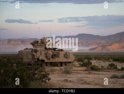 Oregon Army National Guard, M3A2 Bradley Fighting Vehicle from the 3rd Battalion, 116th Cavalry Regimen, 116th Cavalry Brigade Team provides security for the tact assembly area  at the National Training Center, Fort Irwin, California, June, 5, 2019. The Bradley is designed for transporting troops and providing cover fire. (U.S. Air National Guard photo by Senior Airman Mercedee Wilds) Stock Photo