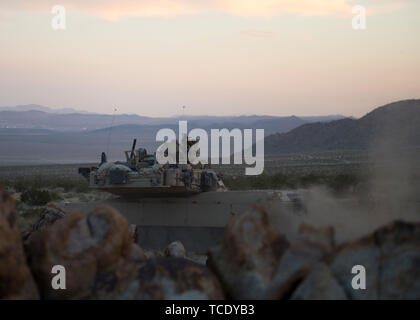 A section of Oregon Army National Guard, M1A2 Abrams Main Battle Tanks, 3rd Battalion, 116th Cavalry Regimen, 116th Cavalry Brigade Team peruses enemy forces after a simulated attack during an exercise at the National Training Center, Fort Irwin, California, June, 5, 2019. The NTC serves as the Army’s premiere training center. (U.S. Air National Guard photo by Senior Airman Mercedee Wilds) Stock Photo