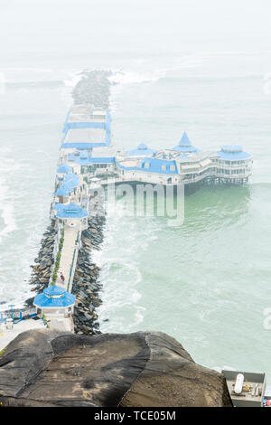 Typically misty day, in Miraflores, overlooking a jetty with restaurant La Rosa Nautica on the coast, Lima,  nicknamed El Gris, the grey, Peru, Stock Photo