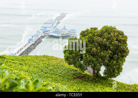 Typically misty day, in Miraflores, overlooking a jetty with restaurant La Rosa Nautica on the coast, Lima,  nicknamed El Gris, the grey, Peru, Stock Photo