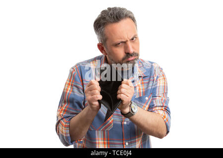 Man with sad or disappointed expression presenting empty brown leather wallet as no money concept isolated on white background Stock Photo