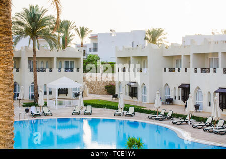 White houses and swimming pool on territory of five star hotel in Sharm El Sheikh. Summer in Egypt. Stock Photo