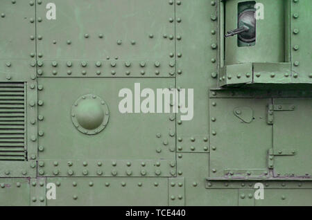 Abstract green industrial metal textured background with rivets and bolts. Old painted metal backdrop, detail of military tank surface corrosion, meta Stock Photo