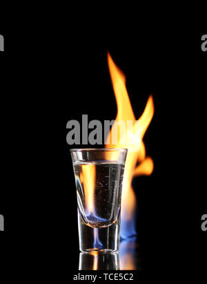 Flaming vodca on black background Stock Photo