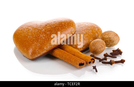 Heart-shaped cookies with cinnamon, nutmegs and carnation isolated on white Stock Photo