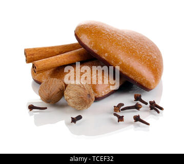 Heart-shaped cookies with cinnamon, nutmegs and carnation isolated on white Stock Photo