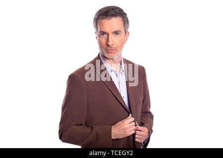 Middle aged bearded businessman on a white background wearing a brown jacket.  The mature man looks like a confident or arrogant business executive. Stock Photo