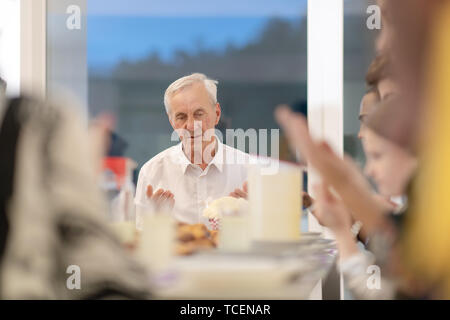 modern muslim family praying before having iftar dinner together during a ramadan feast at home Stock Photo