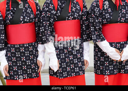 Japanese young girls wearing traditional kimono prepared for planting on the paddy rice farm land Stock Photo