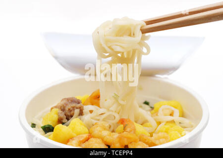 Instant noodles, noodle soup in a cup with chopsticks Stock Photo