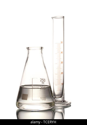 Flask with water and empty measuring beaker with reflection isolated on white Stock Photo