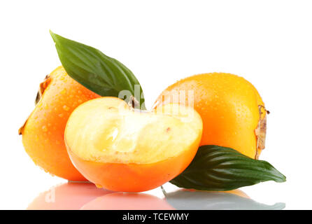 Appetizing persimmons with droplets and leaves isolated on white Stock Photo