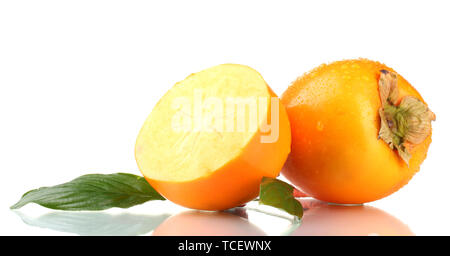 Appetizing persimmons with droplets and leaf isolated on white Stock Photo