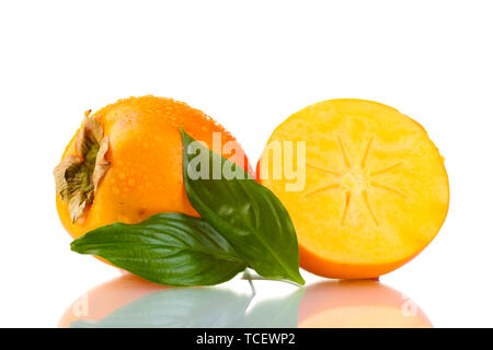 Appetizing persimmons with droplets and leaf isolated on white Stock Photo