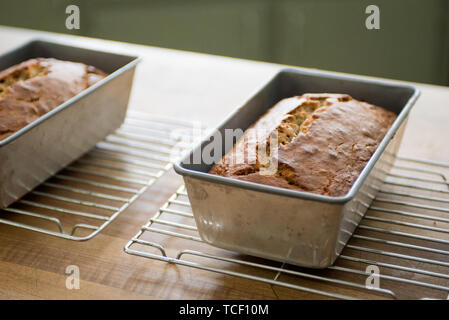 Metal forms on cooling racks with freshly baked buns of bread Stock Photo