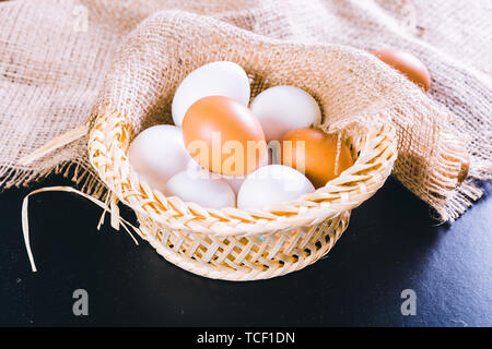 Eggs on tablecloth over black background Stock Photo