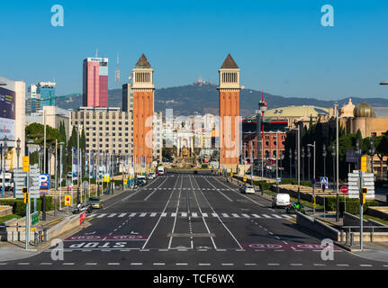 Barcelona, Spain - February 23 2019: View of Venetian Towers in Barcelona with empty street, moutains in the back and sunny day. Stock Photo
