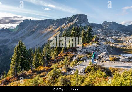 Female hiker on hiking trail at Artist Point, mountain landscape in autumn, Tabletop Mountain in the back, Mount Baker-Snoqualmie National Forest, Was Stock Photo