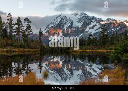 Sunset, Mt. Shuksan glacier with snow reflected in Picture Lake, wooded mountain landscape, Mt. Baker-Snoqualmie National Forest, Washington, USA, Nor Stock Photo