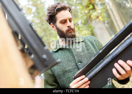 Ranger looks at a bark beetle trap as a means of pest control Stock Photo