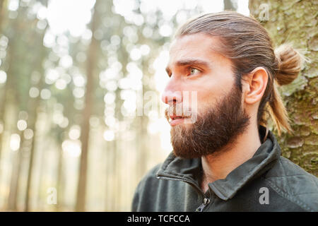 Young forester or forestry worker in training in the forest or forest district Stock Photo