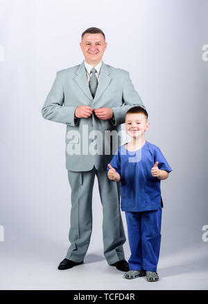 future career. childhood. trust and values. fathers day. family day. father and son in business suit. male fashion. happy child with father. business partner. small boy doctor with dad businessman. Stock Photo
