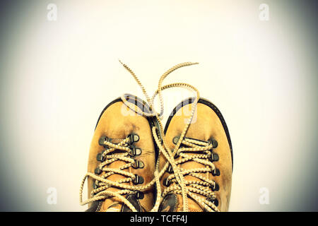 Vintage background yellow shoes with untied shoelaces Stock Photo