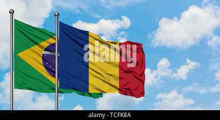 Romania and Brazil flag waving in the wind against white cloudy blue ...
