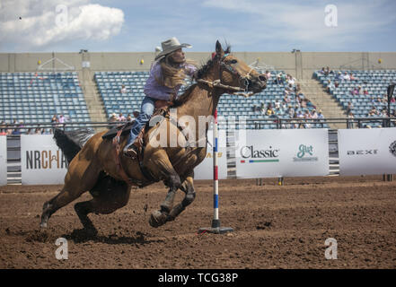 Heber City, Utah, USA. 6th June, 2019. A High School student on horseback takes part in the pole bending event at the Utah High School Rodeo Association Finals in Heber City Utah, June 7, 2019. Students from across the state of Utah gathered to compete in Barrel Racing, Pole Bending, Goat Tying, Breakaway Roping, Cow Cutting, Bull Riding, Bareback Riding, Saddle Bronc Riding, Tie Down Roping, Steer Wrestling, and Team Roping. Credit: Natalie Behring/ZUMA Wire/Alamy Live News Stock Photo