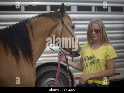 Heber City, Utah, USA. 7th June, 2019. a young woman with her horse at the Utah High School Rodeo Association Finals in Heber City Utah, June 7, 2019. Students from across the state of Utah gathered to compete in Barrel Racing, Pole Bending, Goat Tying, Breakaway Roping, Cow Cutting, Bull Riding, Bareback Riding, Saddle Bronc Riding, Tie Down Roping, Steer Wrestling, and Team Roping. Credit: Natalie Behring/ZUMA Wire/Alamy Live News Stock Photo