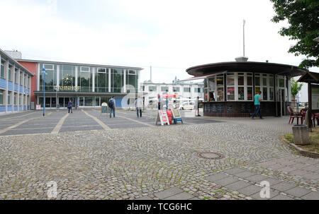 Sangerhausen, Germany. 07th June, 2019. Passers-by walk across the forecourt between Sangerhausen railway station and the round kiosk. The building was erected in 1963 and is a listed building. Credit: Sebastian Willnow/dpa-Zentralbild/dpa/Alamy Live News Stock Photo
