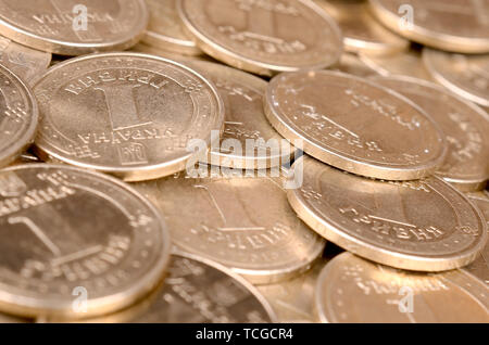 Large pile of big golden coins. Financial success money background for rich life concepts, banking and profit in Ukraine Stock Photo