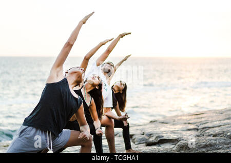 Young attractive women practicing balance acro yoga pose Stock Photo - Alamy