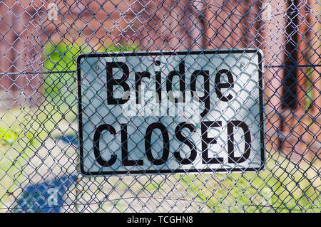 Bridge closed sign in front of dilapidated bridge Stock Photo