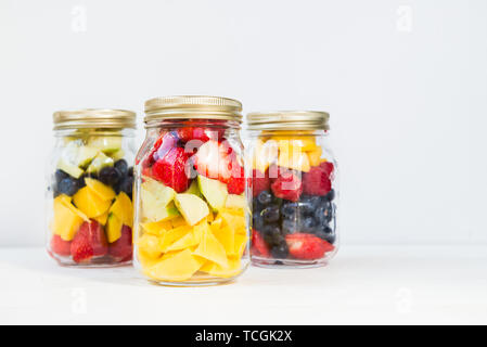 Homemade Fruit and Berry Salads in Jars, Great Idea for Take Away Healthy Snack. Clean or Detox Eating Concept Stock Photo