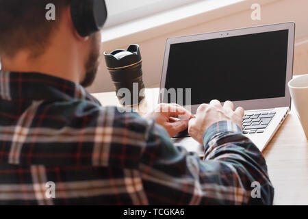Modern workspace of professional artist or photographer, working on laptop computer, tablet , music creator, home interior. Creative process. Stock Photo