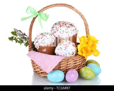 Beautiful Easter cakes in basket, colorful eggs and flowers isolated on white Stock Photo
