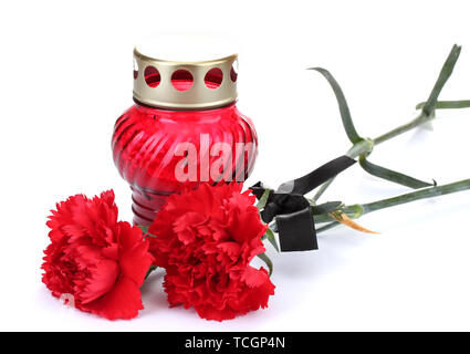 Memory lantern with candle,  carnations and black ribbon isolated on white Stock Photo