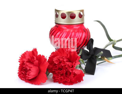 Memory lantern with candle,  carnations and black ribbon isolated on white Stock Photo