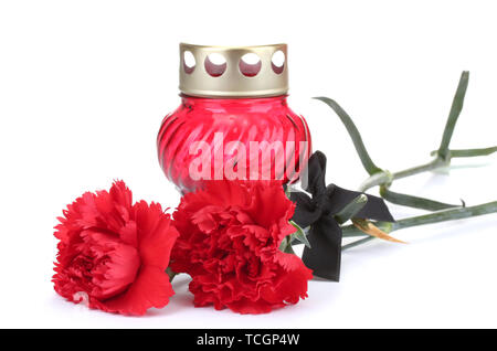 Memory lantern with candle,  carnations and black ribbon isolated on white Stock Photo